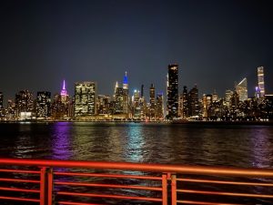 View of NYC at night over the water